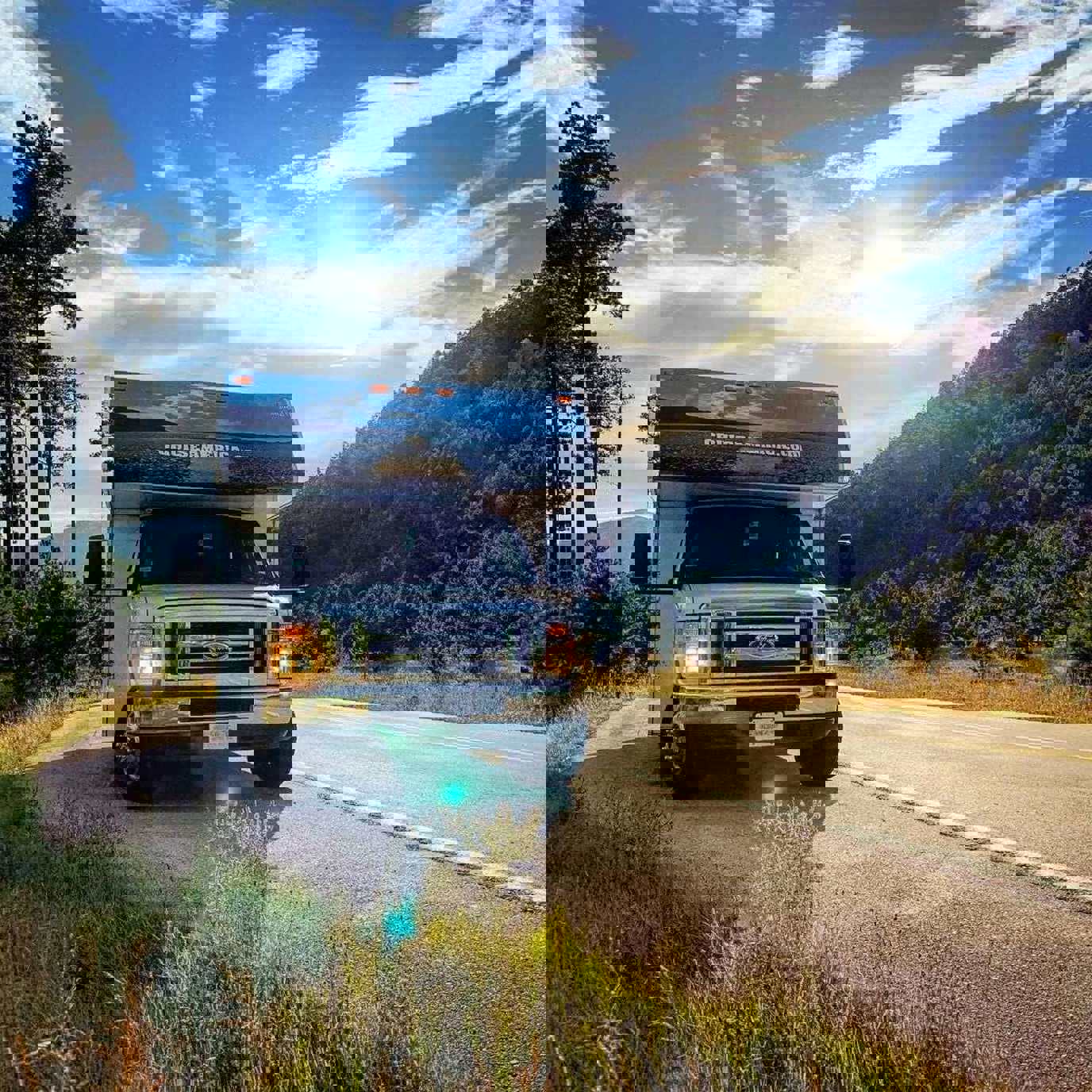 Front view of RV parked on mountain road