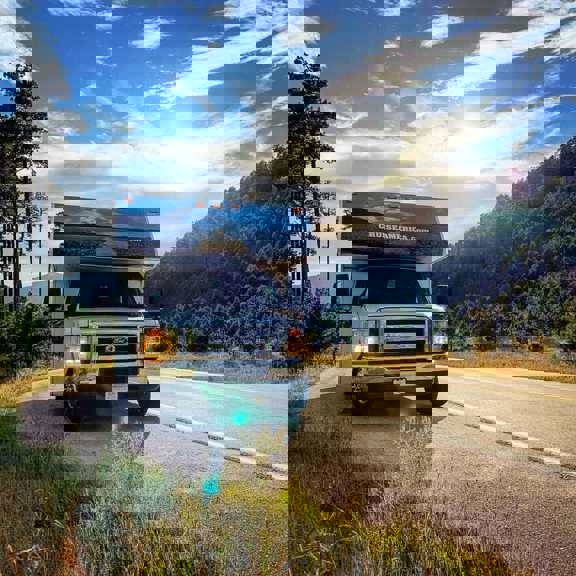 Front view of RV parked on mountain road