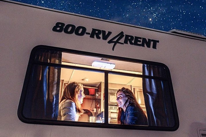 Travelers enjoying an evening in a Cruise America RV.